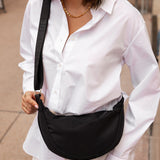The Louenhide Sylvia Nylon Crossbody Bag is an on-trend style, featuring a modern crescent silhouette.