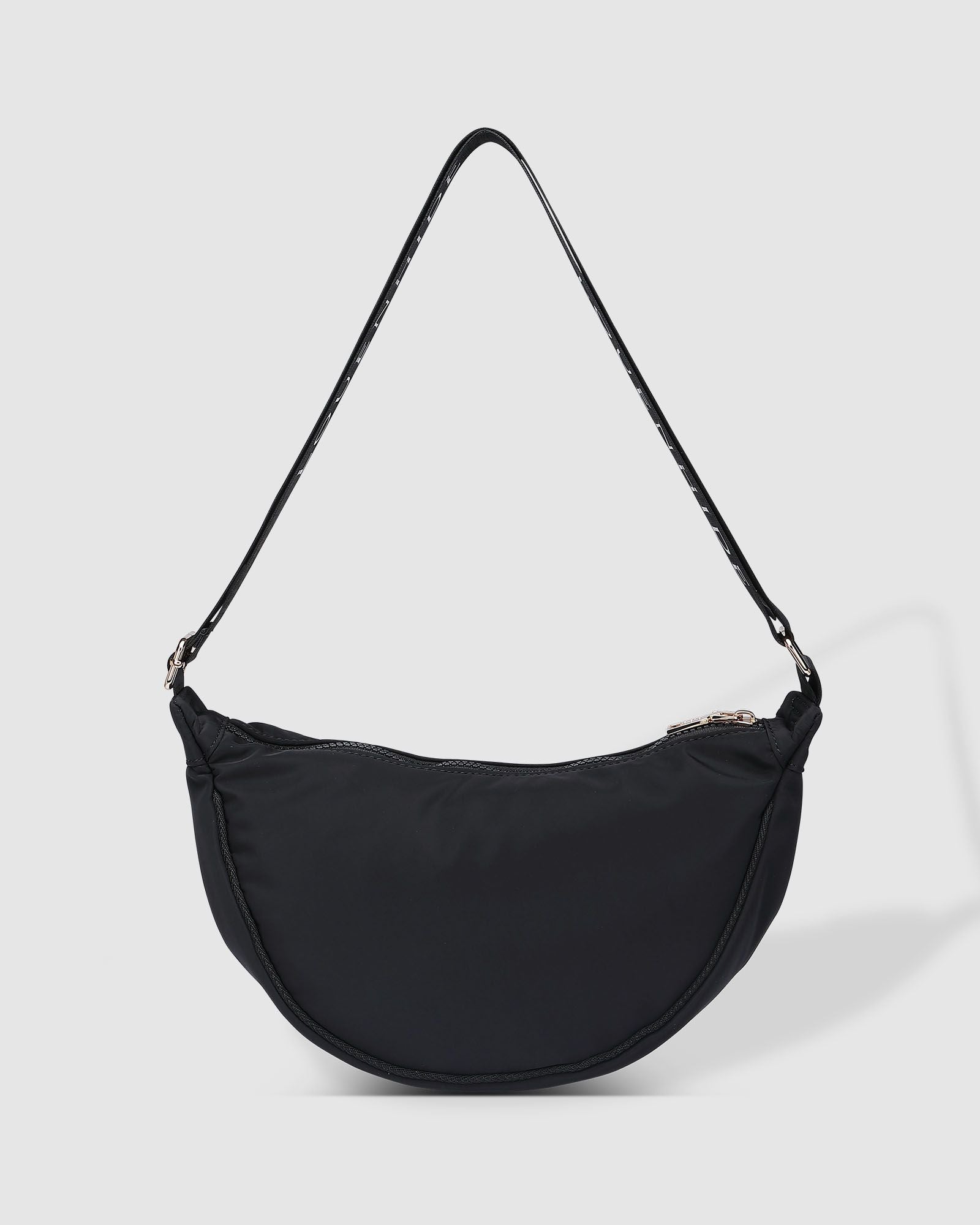 The Louenhide Sylvia Nylon Crossbody Bag is an on-trend style, featuring a modern crescent silhouette.