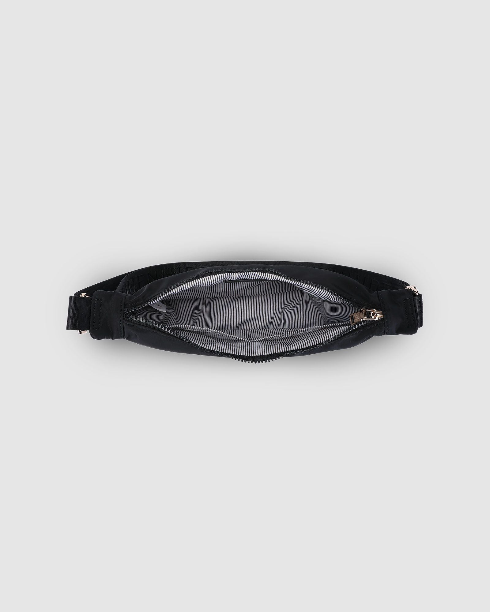 The Louenhide Sylvia Nylon Crossbody Bag is an on-trend style, featuring a modern crescent silhouette.