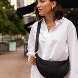 The Louenhide Sylvia Nylon Crossbody Bag is an on-trend style, featuring a modern crescent silhouette.