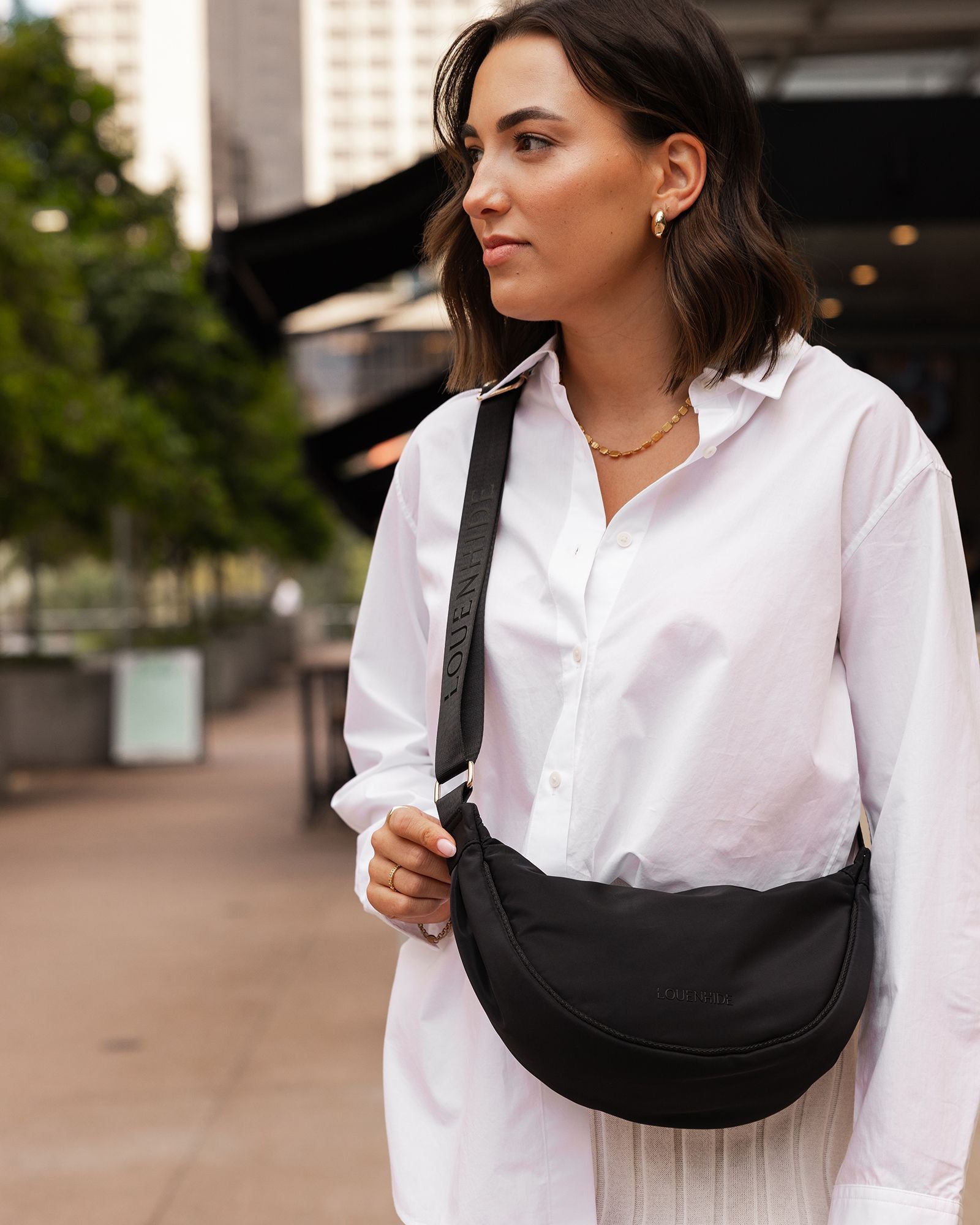 The Louenhide Sylvia Nylon Crossbody Bag is an on-trend style, featuring a modern crescent silhouette.