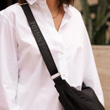 The Louenhide Sylvia Nylon Crossbody Bag is an on-trend style, featuring a modern crescent silhouette.