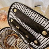 The Louenhide Trudy Jewelry Box is the perfect solution to keeping your valuables safely organized on the go. This compact travel jewelry case fits seamlessly into your luggage without taking up space. The secure zip closure ensures your jewelry stays protected, while the textured raffia and contrasting faux leather exterior add a touch of understated luxury to your travel style.