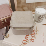 The Louenhide Beau Jewelry Box is a small, square jewellery organizer designed to keep your pieces safe and secure at home or when you are on the go. Featuring a vegan croc exterior, the Beau is every woman's dream jewelry case! Store your larger pieces in the main compartment, while safely stowing your smaller jewels in the elasticated slip pocket