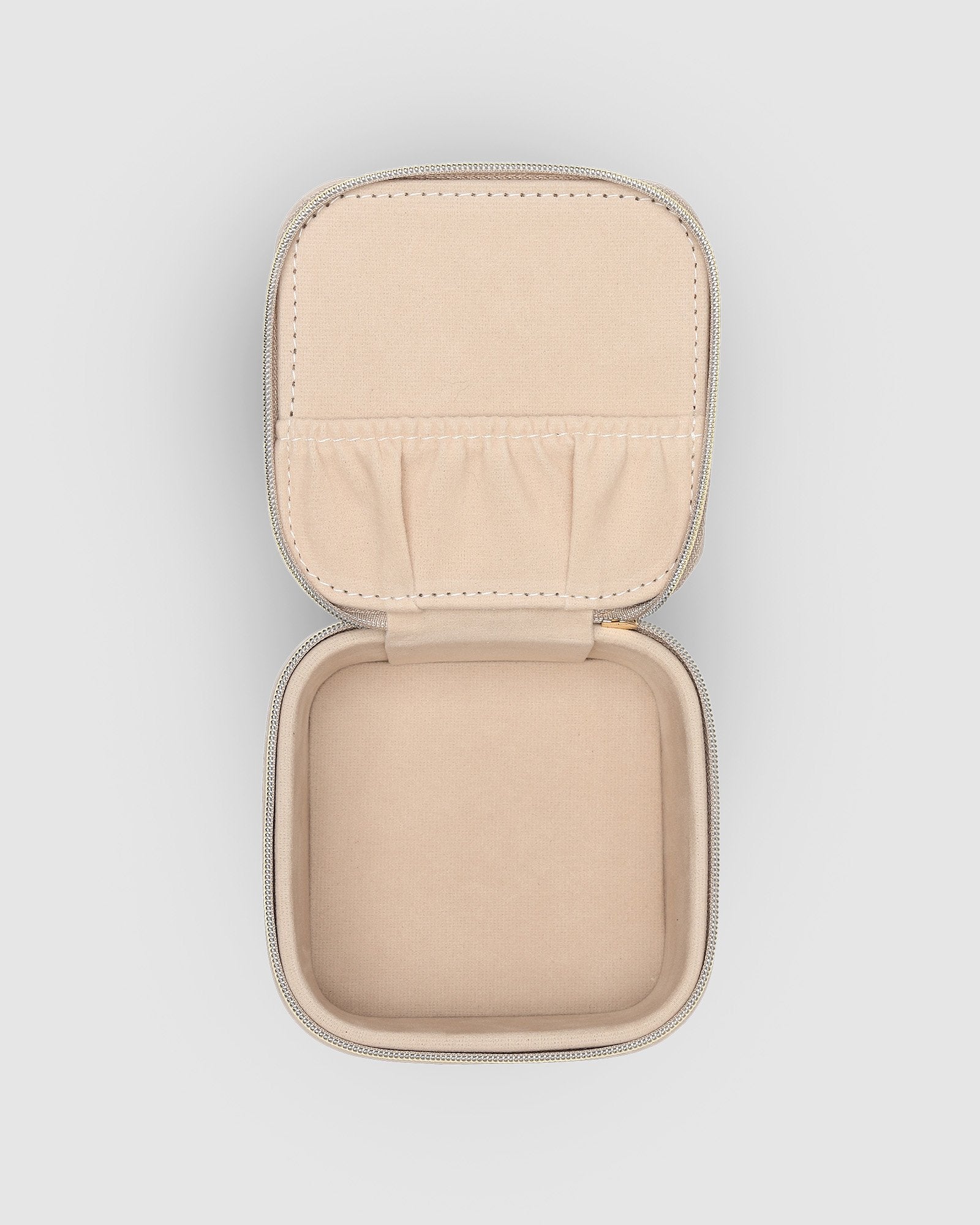 The Louenhide Beau Jewelry Box is a small, square jewellery organizer designed to keep your pieces safe and secure at home or when you are on the go. Featuring a vegan croc exterior, the Beau is every woman's dream jewelry case! Store your larger pieces in the main compartment, while safely stowing your smaller jewels in the elasticated slip pocket