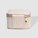 The Louenhide Beau Jewelry Box is a small, square jewellery organizer designed to keep your pieces safe and secure at home or when you are on the go. Featuring a vegan croc exterior, the Beau is every woman's dream jewelry case! Store your larger pieces in the main compartment, while safely stowing your smaller jewels in the elasticated slip pocket