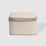 The Louenhide Beau Jewelry Box is a small, square jewellery organizer designed to keep your pieces safe and secure at home or when you are on the go. Featuring a vegan croc exterior, the Beau is every woman's dream jewelry case! Store your larger pieces in the main compartment, while safely stowing your smaller jewels in the elasticated slip pocket
