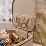 The Louenhide Beau Jewelry Box is a small, square jewellery organizer designed to keep your pieces safe and secure at home or when you are on the go. Featuring a vegan croc exterior, the Beau is every woman's dream jewelry case! Store your larger pieces in the main compartment, while safely stowing your smaller jewels in the elasticated slip pocket