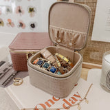 The Louenhide Beau Jewelry Box is a small, square jewellery organizer designed to keep your pieces safe and secure at home or when you are on the go. Featuring a vegan croc exterior, the Beau is every woman's dream jewelry case! Store your larger pieces in the main compartment, while safely stowing your smaller jewels in the elasticated slip pocket