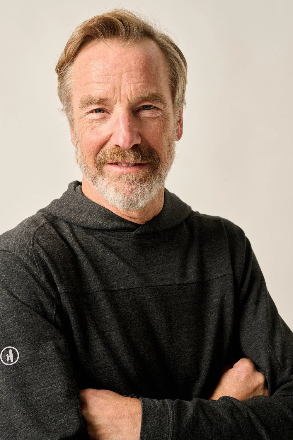 Man wearing a dark gray sweater against a plain background