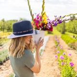 The Sedona sun hat stands out with its vibrant, multicolor embroidered band, adding a touch of artistic flair to your look. Its structured brim offers ample shade and sun protection, perfect for carefree days outdoors. With a packable design, it easily folds for adventures near and far.