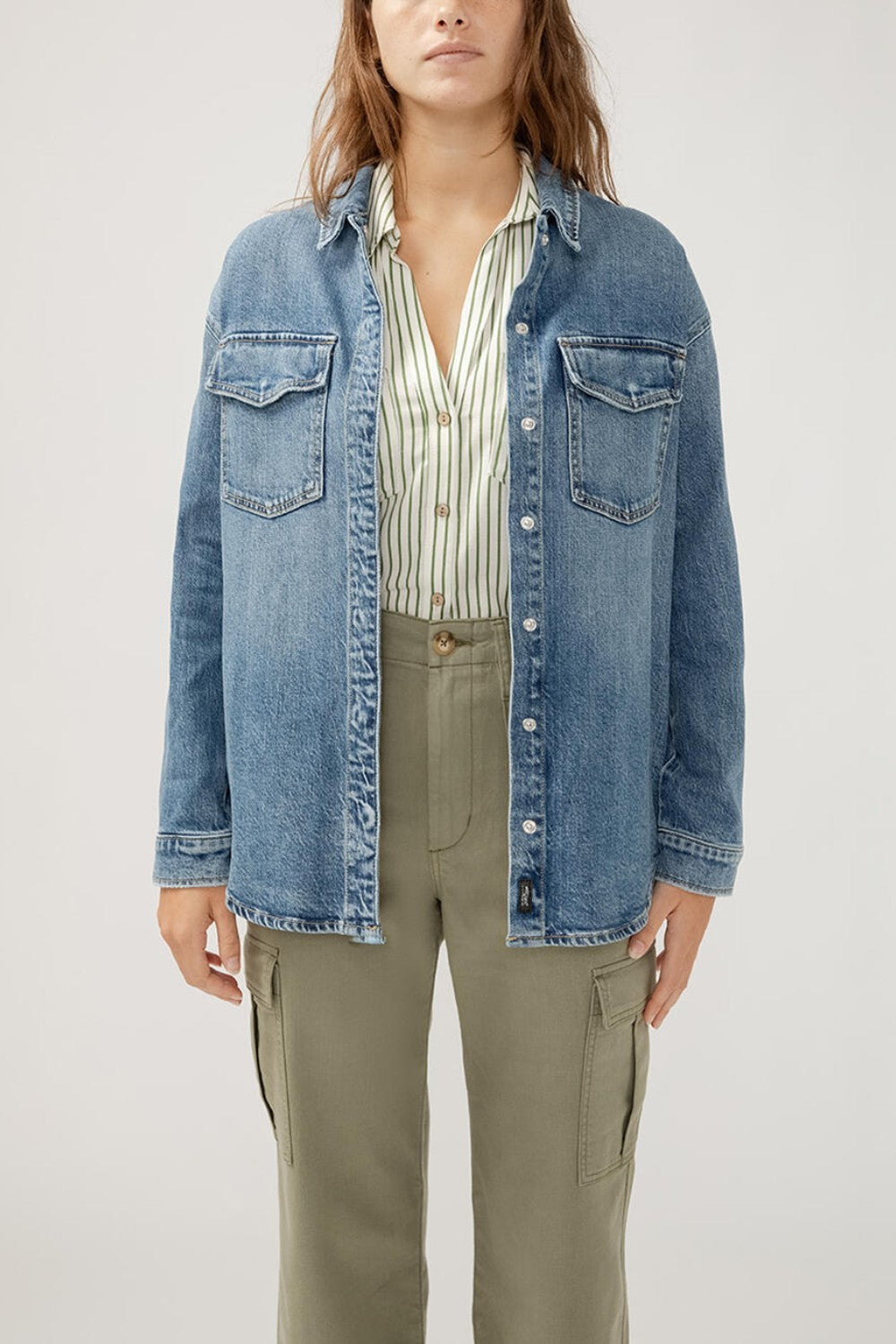 The perfect layer for any season? A denim shacket. This stylish top layer combines the structure of a jacket with the ease of a shirt, featuring a relaxed fit and oversized pockets. Wear it open or buttoned up, dressed up or down—this jean shacket is sure to be your new staple layer.