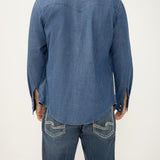 Person wearing a blue denim shirt and jeans on a white background