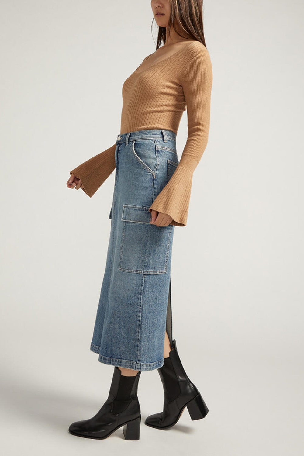 Meet your staple denim skirt for spring and beyond. Our medium wash midi cargo skirt is the perfect statement piece, dressed up or down. With side cargo pockets and a back slit, this is a skirt you'll love wearing everywhere.