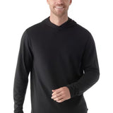 Man wearing a black hoodie and blue pants on a white background