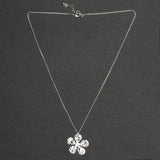 Add a touch of whimsy to your wardrobe with our Hammered Flower Pendant On Chain. Each silver plated pendant features a unique floral design, making it the perfect accessory for any outfit.