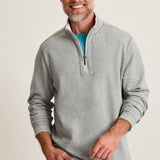 Man wearing a gray pullover with a white background