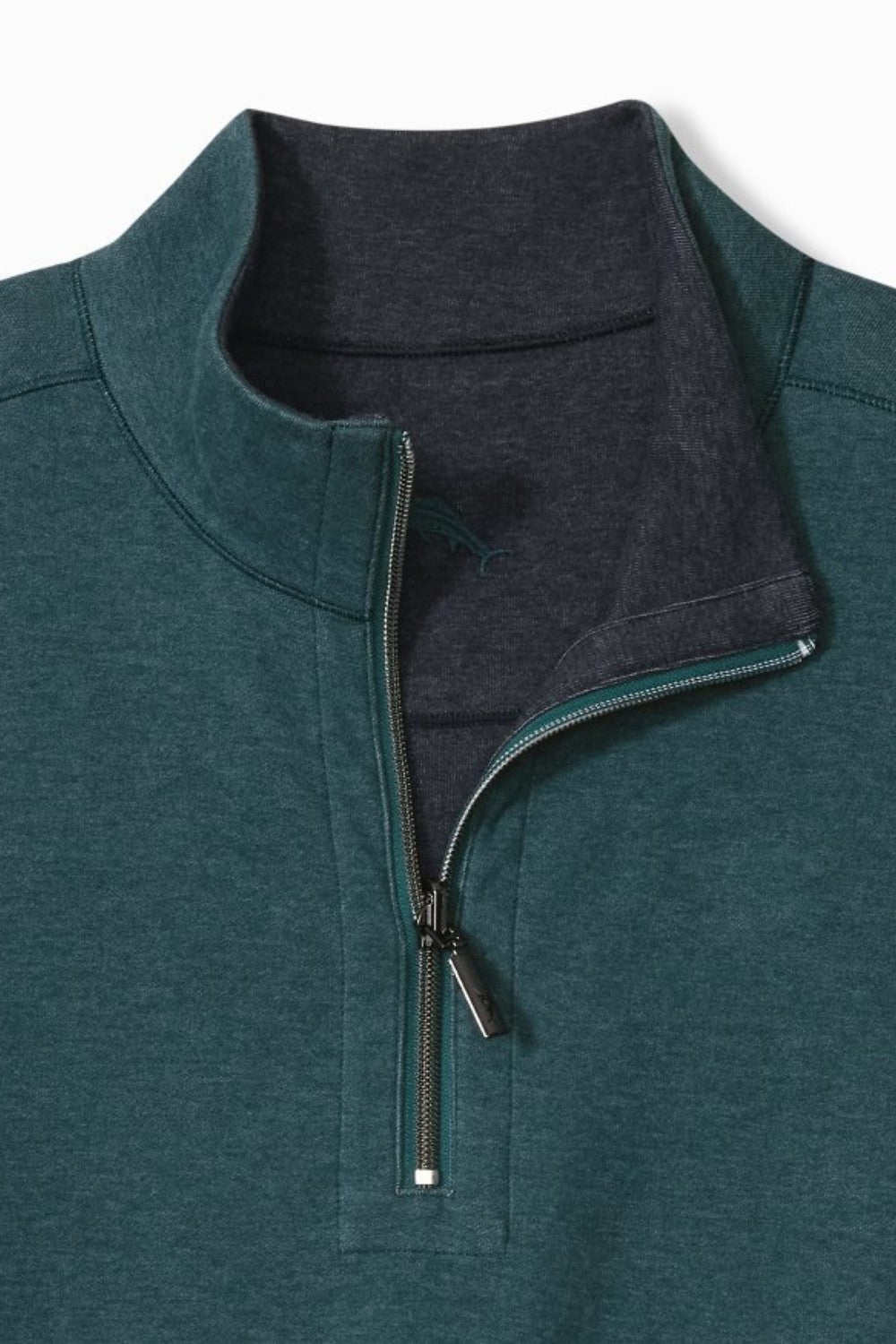 Close-up of a green pullover with a zipper collar on a white background