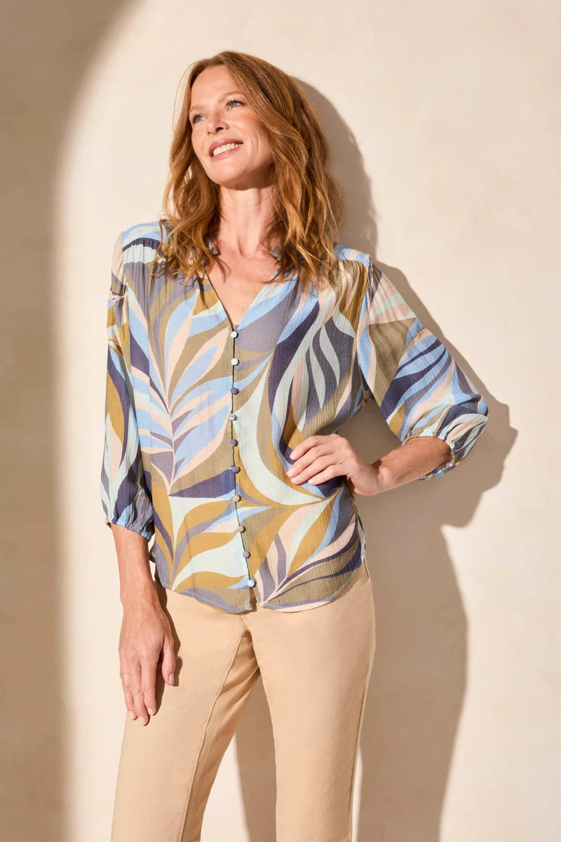 Refresh your wardrobe with this button-front blouse, featuring a vibrant print and textured woven fabric for a luxurious feel. Three-quarter-length sleeves provide ideal coverage, with elastic cuffs that make rolling a breeze. A ruffle detail at the collar adds a subtle touch of finesse.
