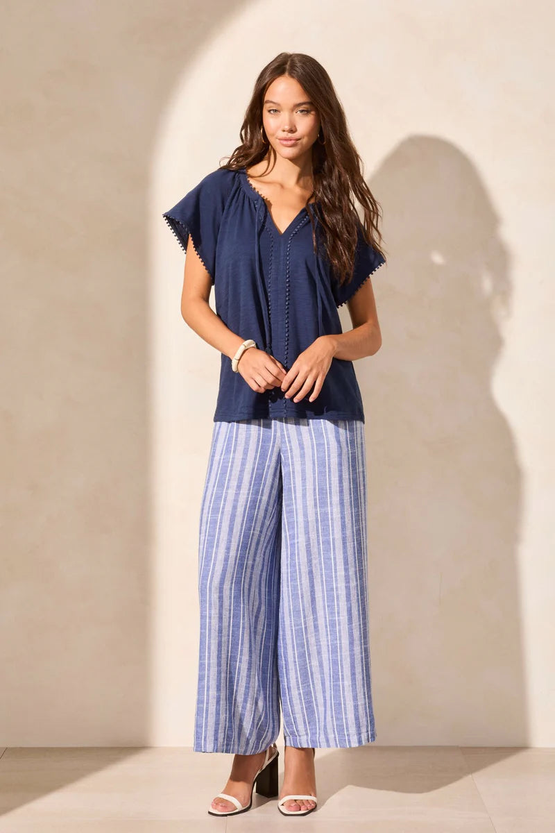 Infuse your look with effortless boho charm in this short-sleeve top, featuring a notch neckline with tassel-tipped ties. Made from soft cotton slub knit, it offers a breathable, comfortable feel. A contour band accentuates the neckline, while braided edge trim adds a refined touch to the design.