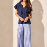 Infuse your look with effortless boho charm in this short-sleeve top, featuring a notch neckline with tassel-tipped ties. Made from soft cotton slub knit, it offers a breathable, comfortable feel. A contour band accentuates the neckline, while braided edge trim adds a refined touch to the design.