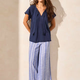 Infuse your look with effortless boho charm in this short-sleeve top, featuring a notch neckline with tassel-tipped ties. Made from soft cotton slub knit, it offers a breathable, comfortable feel. A contour band accentuates the neckline, while braided edge trim adds a refined touch to the design.