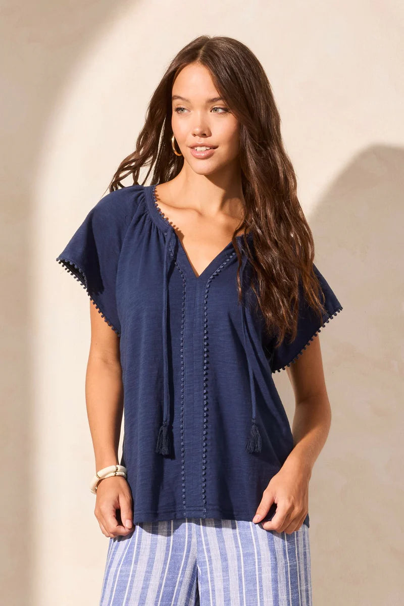 Infuse your look with effortless boho charm in this short-sleeve top, featuring a notch neckline with tassel-tipped ties. Made from soft cotton slub knit, it offers a breathable, comfortable feel. A contour band accentuates the neckline, while braided edge trim adds a refined touch to the design.
