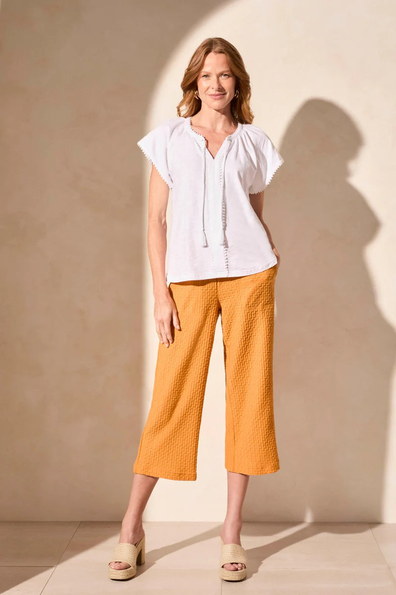 Infuse your look with effortless boho charm in this short-sleeve top, featuring a notch neckline with tassel-tipped ties. Made from soft cotton slub knit, it offers a breathable, comfortable feel. A contour band accentuates the neckline, while braided edge trim adds a refined touch to the design