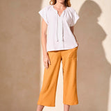 Infuse your look with effortless boho charm in this short-sleeve top, featuring a notch neckline with tassel-tipped ties. Made from soft cotton slub knit, it offers a breathable, comfortable feel. A contour band accentuates the neckline, while braided edge trim adds a refined touch to the design