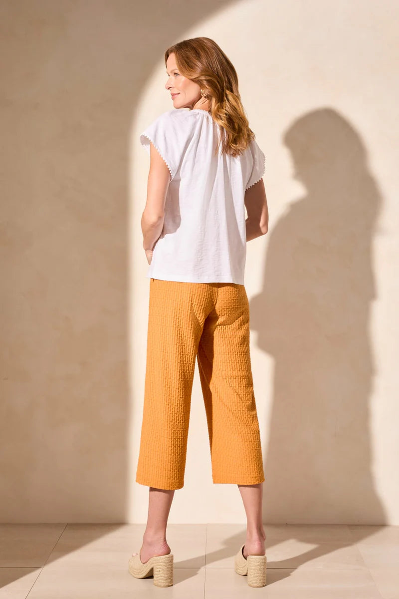 Infuse your look with effortless boho charm in this short-sleeve top, featuring a notch neckline with tassel-tipped ties. Made from soft cotton slub knit, it offers a breathable, comfortable feel. A contour band accentuates the neckline, while braided edge trim adds a refined touch to the design