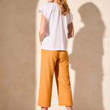 Infuse your look with effortless boho charm in this short-sleeve top, featuring a notch neckline with tassel-tipped ties. Made from soft cotton slub knit, it offers a breathable, comfortable feel. A contour band accentuates the neckline, while braided edge trim adds a refined touch to the design