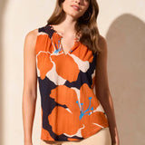 Stay cool and chic on warm days with this breezy sleeveless top, made from a breathable linen-blend knit. The smocked detail adds flattering structure to the elegant notch neckline, while the bold floral print infuses your look with vibrant color and fresh energy.