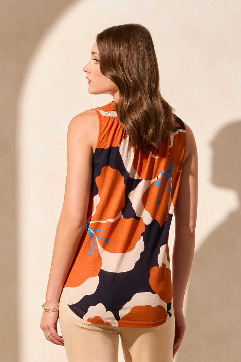 Stay cool and chic on warm days with this breezy sleeveless top, made from a breathable linen-blend knit. The smocked detail adds flattering structure to the elegant notch neckline, while the bold floral print infuses your look with vibrant color and fresh energy.