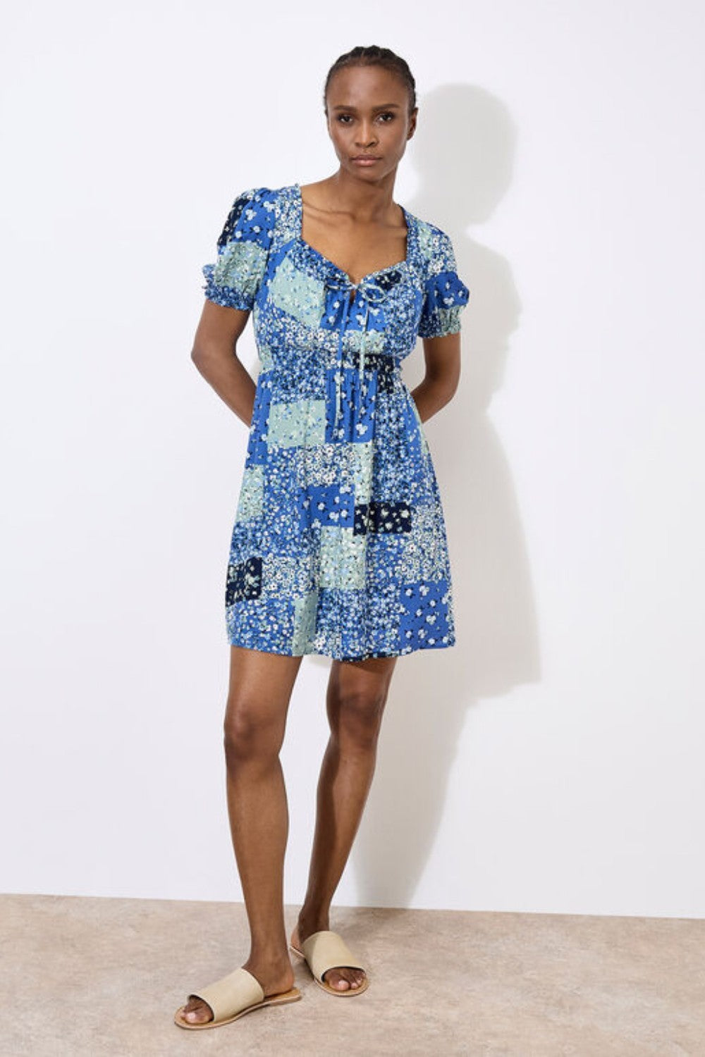 Work boho prints into your weekend wardrobe with this ditsy patchwork mini dress. Framed by a sweetheart neck with a tie and pretty puff sleeves, it's finished with a smocked waist for a comfortable and defining fit. Throw on and go with trainers or sandals on sunny days.