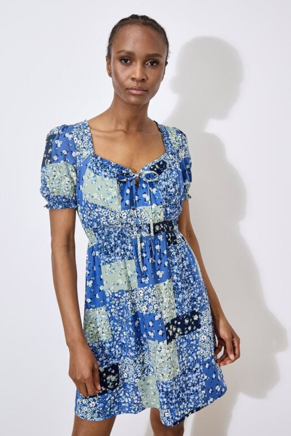 Work boho prints into your weekend wardrobe with this ditsy patchwork mini dress. Framed by a sweetheart neck with a tie and pretty puff sleeves, it's finished with a smocked waist for a comfortable and defining fit. Throw on and go with trainers or sandals on sunny days.