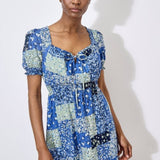 Work boho prints into your weekend wardrobe with this ditsy patchwork mini dress. Framed by a sweetheart neck with a tie and pretty puff sleeves, it's finished with a smocked waist for a comfortable and defining fit. Throw on and go with trainers or sandals on sunny days.