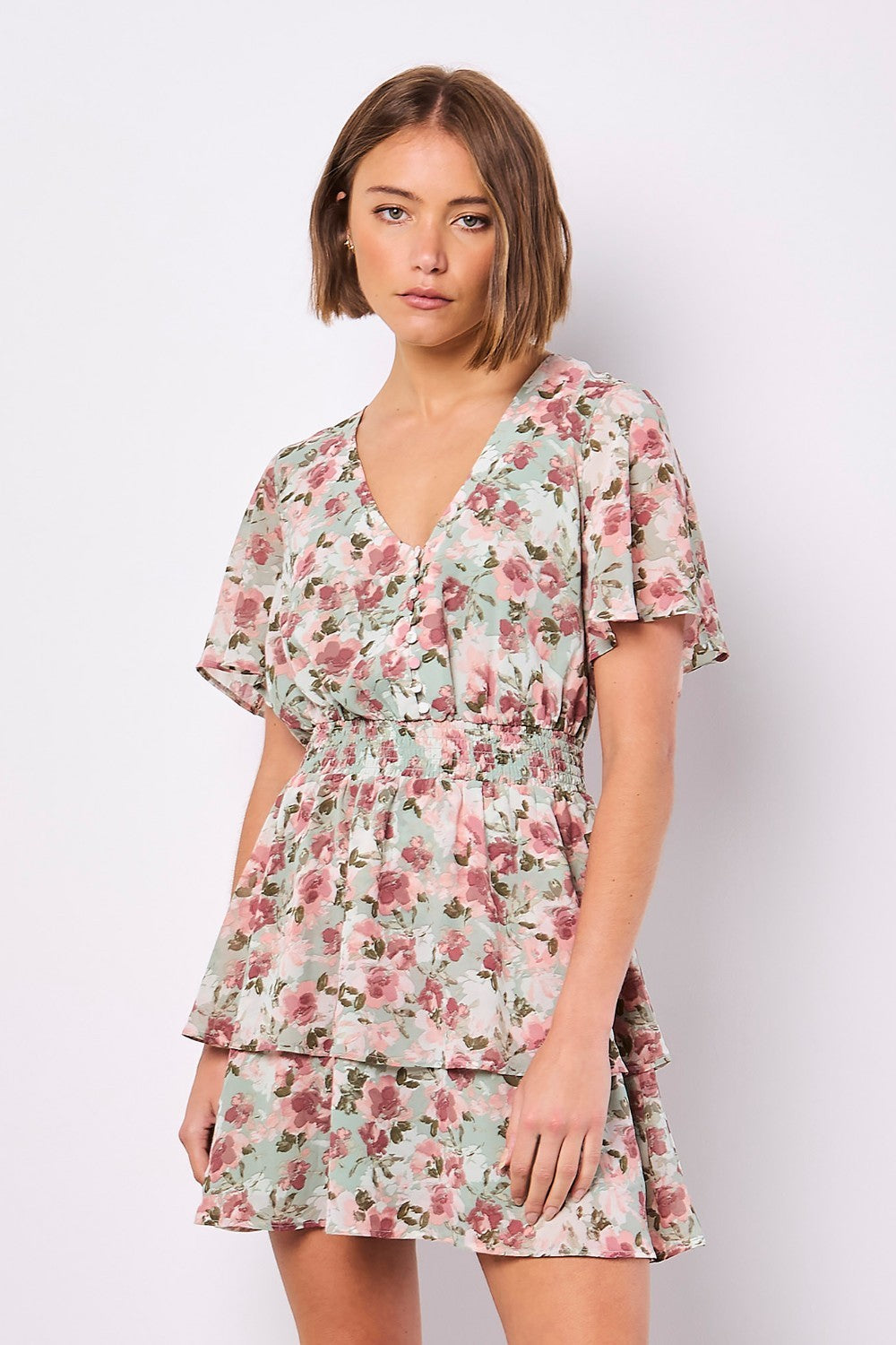 Boasting a mood-boosting watercolour floral print, this mini dress is a must-have for warm days. Crafted from floaty chiffon and lined for comfort, it features a flattering smocked waist, a V-neckline with button-down bodice, and a ruffle-tiered skirt to create movement. Simply style with sandals to complete the look.