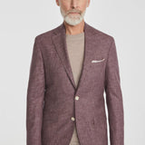 This Midland solid berry blazer is crafted from supersoft and light wool woven in Italy. This fabric allows the wearer to enjoy a crease free linen look thanks to the different colors of yarns used in this 100% worsted wool fabric.