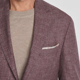 This Midland solid berry blazer is crafted from supersoft and light wool woven in Italy. This fabric allows the wearer to enjoy a crease free linen look thanks to the different colors of yarns used in this 100% worsted wool fabric.