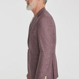 This Midland solid berry blazer is crafted from supersoft and light wool woven in Italy. This fabric allows the wearer to enjoy a crease free linen look thanks to the different colors of yarns used in this 100% worsted wool fabric.