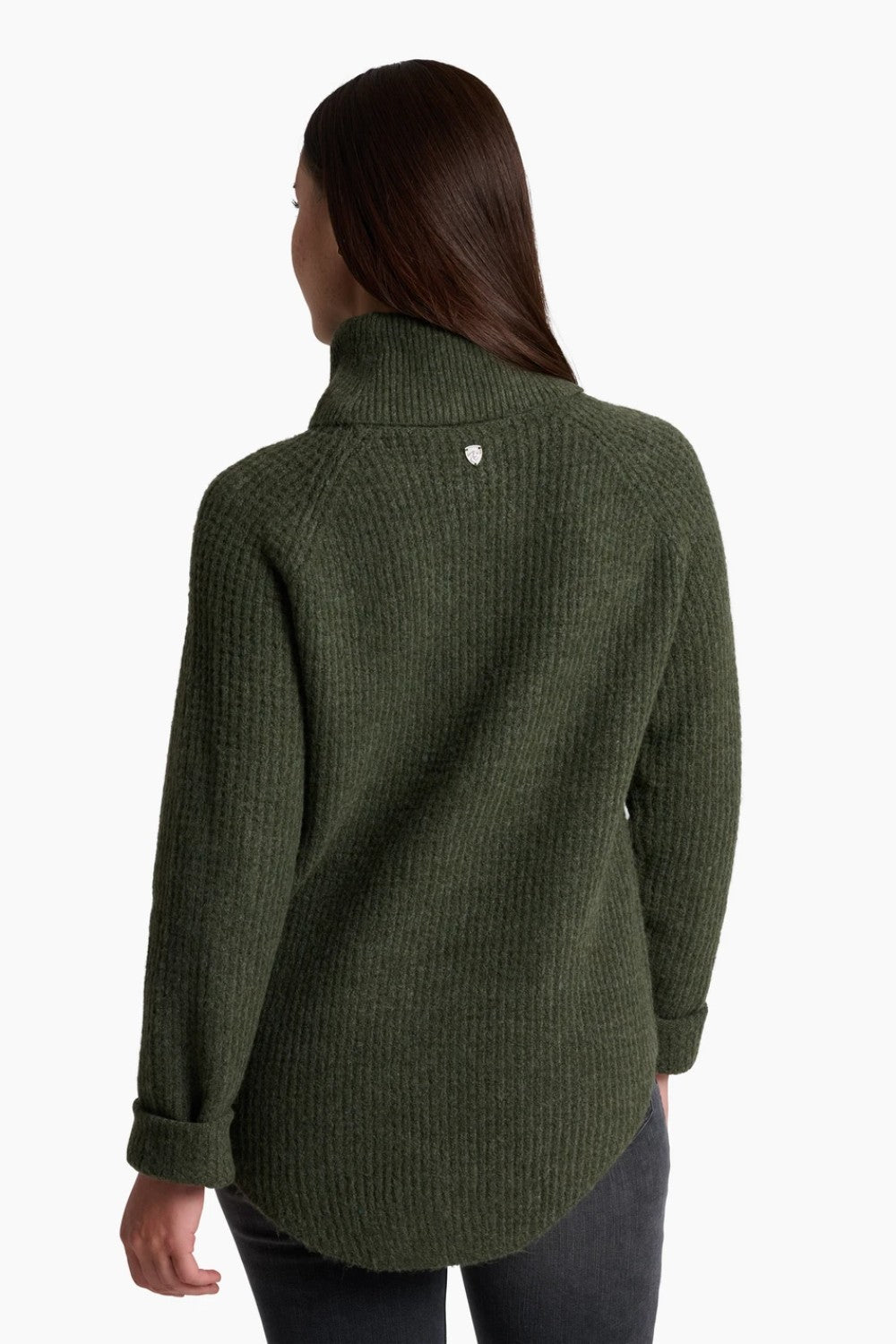 Green knitted sweater worn by a person on a white background