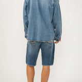 The perfect layer for any season? A men's denim shacket. This stylish top layer combines the structure of a jacket with the ease of a shirt, featuring a relaxed fit and oversized pockets. Wear it open or buttoned up, this jean shacket is sure to be your new staple layer.