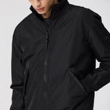 Person wearing a black jacket on a white background