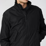 Man wearing a black jacket against a white background