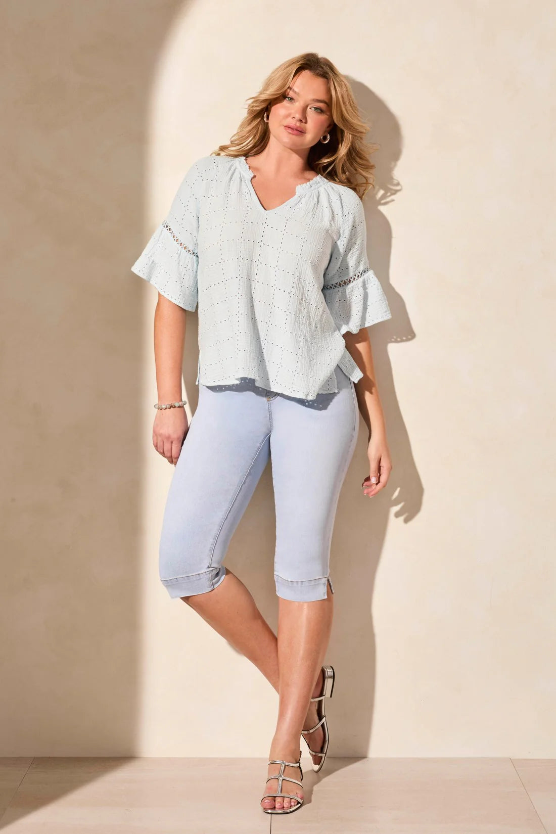 Infuse your day with laid-back elegance in this relaxed blouse, featuring ruffle-finished sleeves adorned with ladder tape detail. A frill accent elegantly frames the poised notch neckline. Made from cotton eyelet gauze, this blouse offers beautiful texture and comfort.