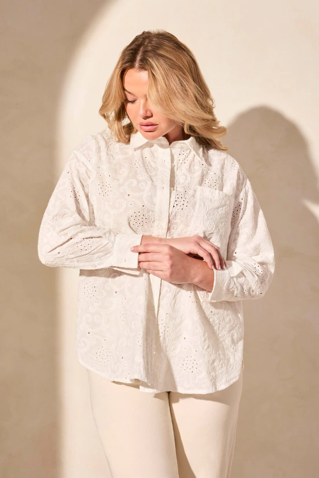 Exquisite embroidered eyelet details enhance the elegance of this classic button-front shirt. The timeless collar frames your face with refined charm, while long sleeves offer comfortable coverage. Crafted from woven cotton fabric, it ensures a breathable feel.