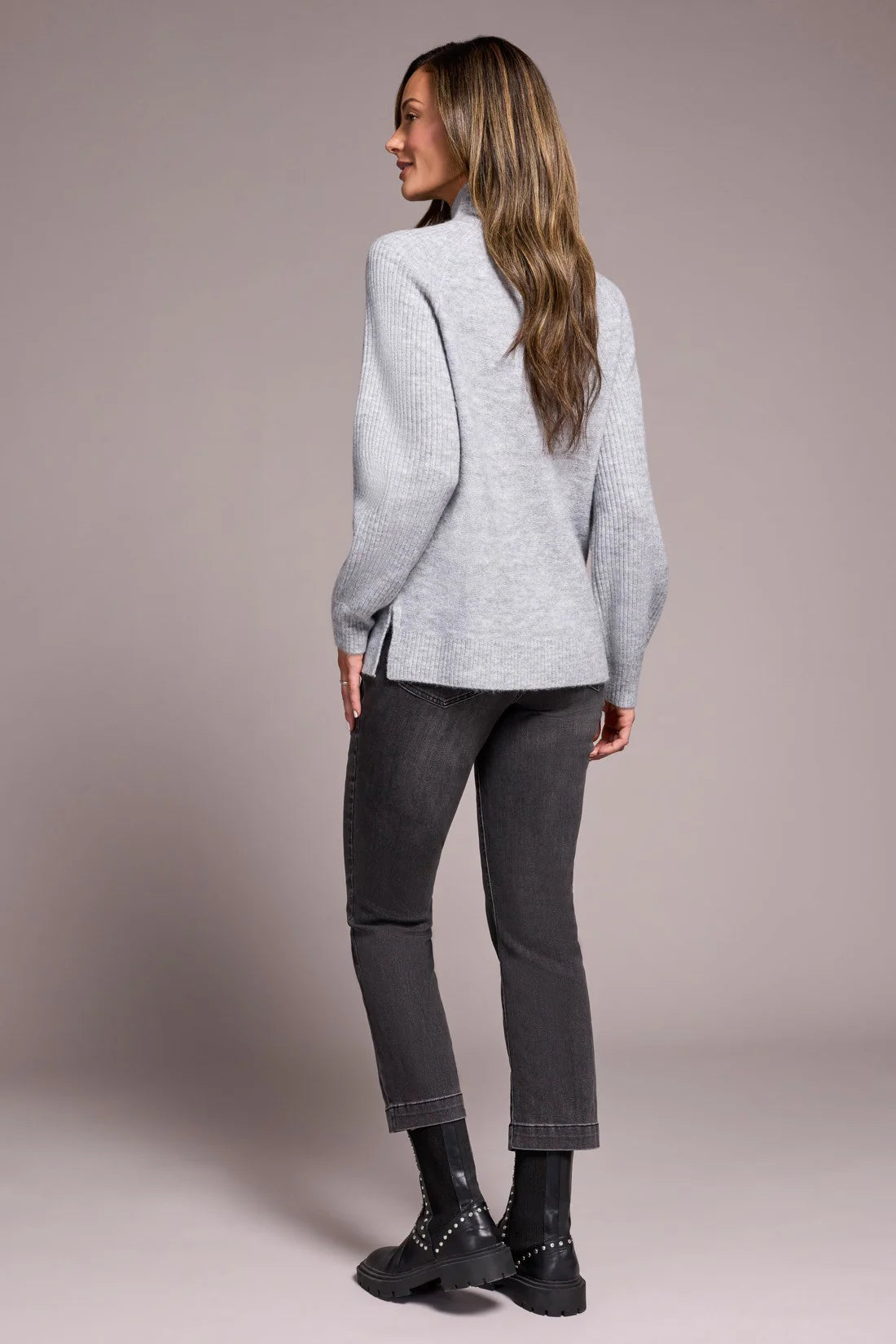 Cooler days call for this cozy sweater, crafted from a soft blend yarn with a rich texture for a luxurious feel. A sleek mock neckline and long puff sleeves add effortless elegance, while fitted cuffs create a refined finish.