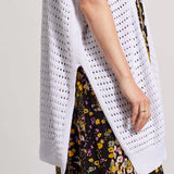 Open-knit crochet fabric, extra long side slits, and a closure-free front keep this sweater cardigan feeling easy and breezy. We love the sleeveless design with extended shoulders, longline hem, and ribbed finishing that outlines the look.
