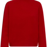 A red turtle neck sweater photographed against a light backdrop.