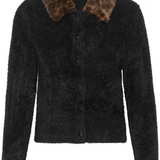 A black button front cardigan, with an animal print collar, photographed against a light backdrop.